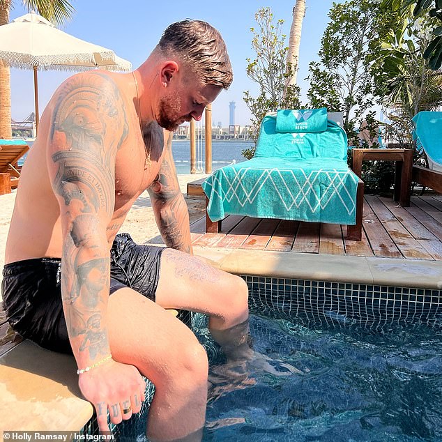 Among her snaps from her and Olympian Adam's Dubai trips was one of the swimmer sat topless by a pool