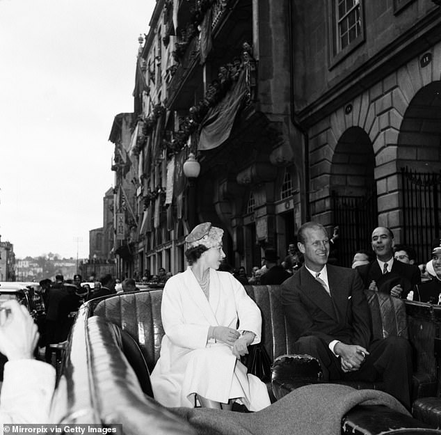 The Queen and Philip riding a carriage through Oporto in Portugal in 1957