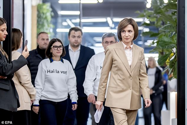 President of Moldova Maia Sandu (R) arrives to her press briefing in Chisinau, Moldova, early 21 October 2024