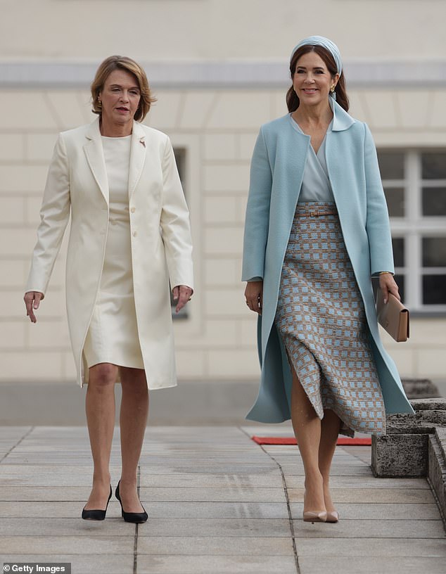 Lady Elke Büdenbender chose donned a cream longline blazer jacket and a ivory coloured dress, complete with black heels