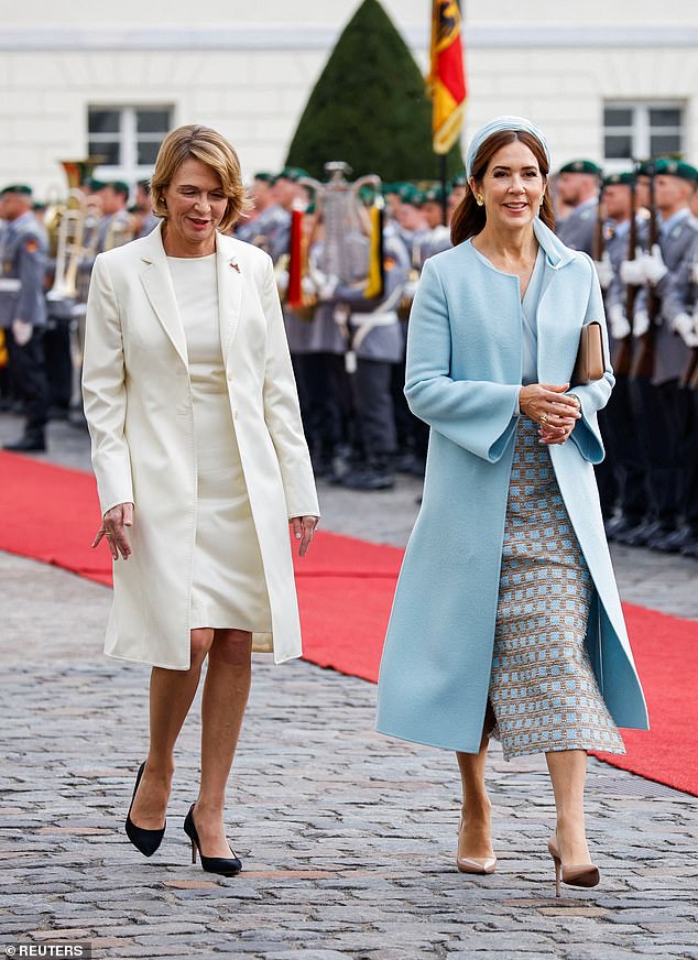 Queen Mary of Denmark beamed as she walked alongside Lady Elke Büdenbender in Berlin today