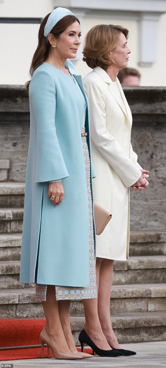 Mary accessorised with a baby blue hairband which she tied around her head, shiny nude pointed heels, a hazelnut-coloured clutch bag and large gold circular stud earrings