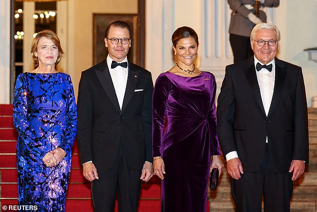 Victoria (centre) picked a floor-length gown, as she arrived for the official dinner with her husband, Daniel, Crown Prince of Sweden.