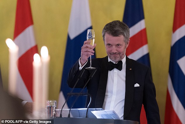 King Frederik of Denmark raises a toast the gala dinner in Berlin