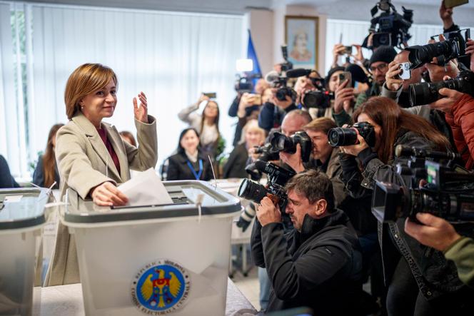 Moldova's President Maia Sandu prepares to cast her vote, in Chisinau, Moldova, Sunday, October 20, 2024.