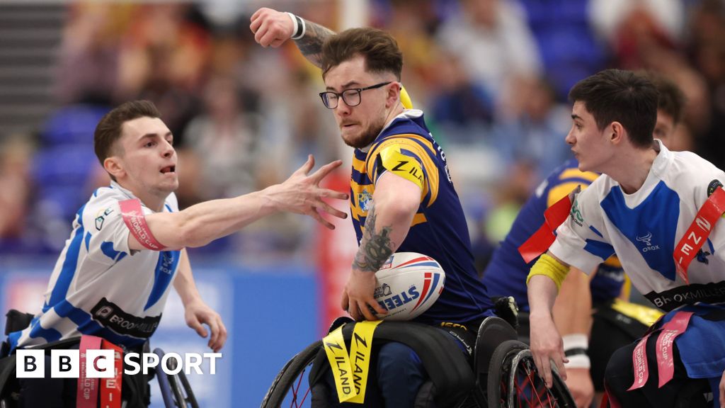 Josh Butler surges between two opponents during Leeds' Wheelchair Super League Grand Final win over Halifax