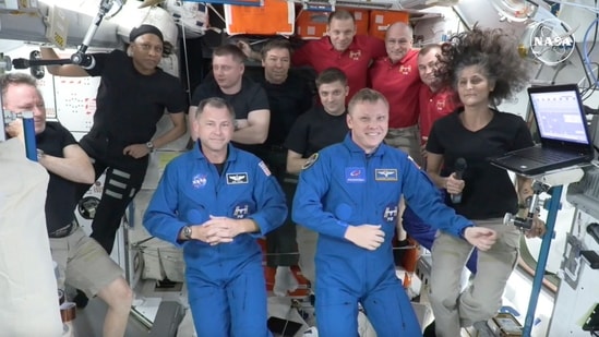 In this image made from a NASA livestream, the two astronauts stuck at the International Space Station since June 2024, Butch Wilmore, far left, and Suni Williams, far right, welcome two new residents who flew up on SpaceX, NASA's Nick Hague, front left in blue, and the Russian Space Agency's Alexander Gorbunov, front right in blue, Sunday, Sept. 29, 2024. Behind them, from left in black, are NASA's Jeanette Epps, Russia's Alexander Grebenkin, NASA's Mike Barratt and NASA's Matthew Dominick. From left, wearing red, are Russia's Ivan Vagner, NASA's Don Pettit and Russia's Alexei Ovchinin. (AP)