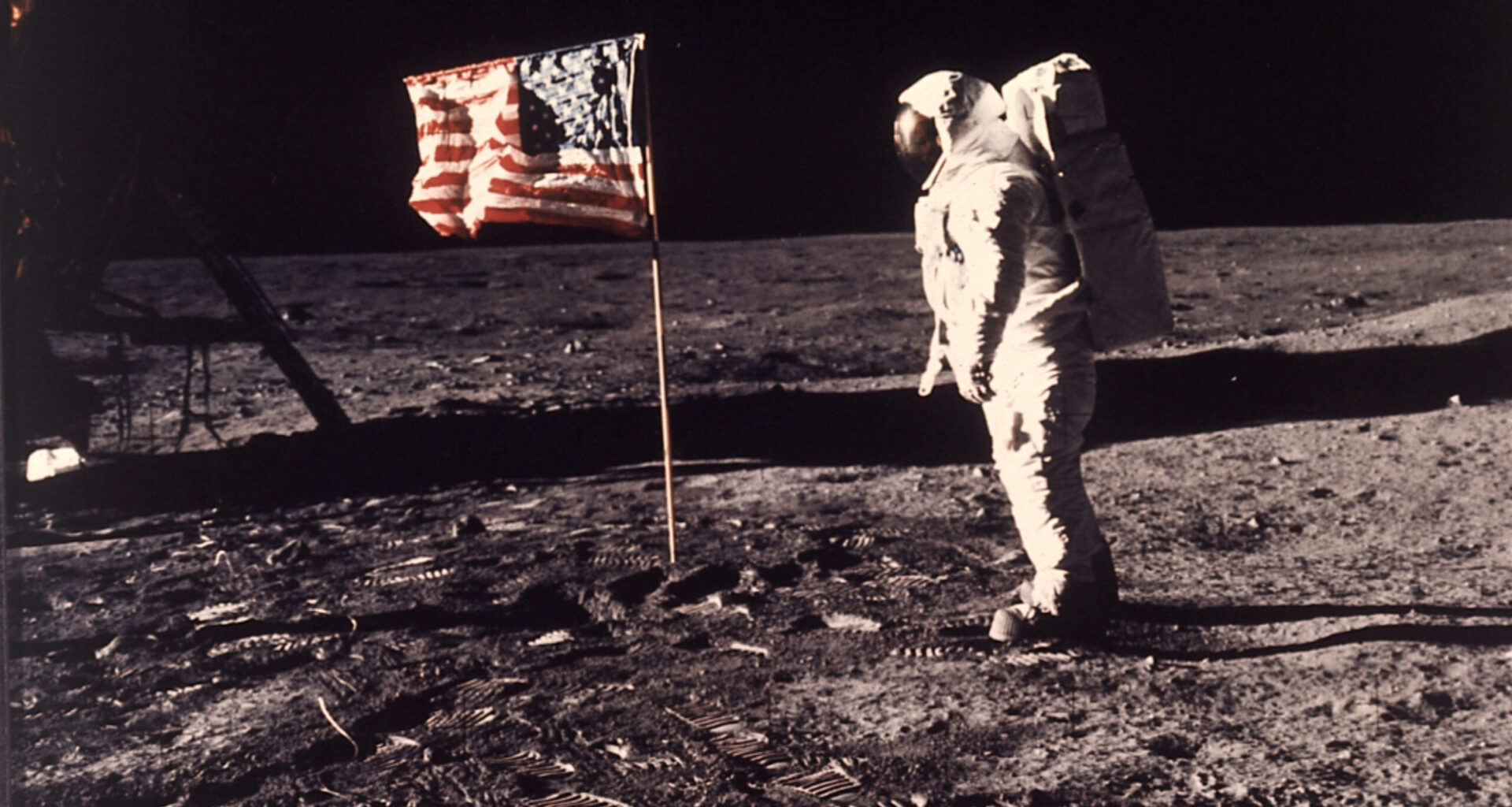 FILE - Astronaut Edwin "Buzz" Aldrin poses for a photograph beside the U.S. flag deployed on the mo...