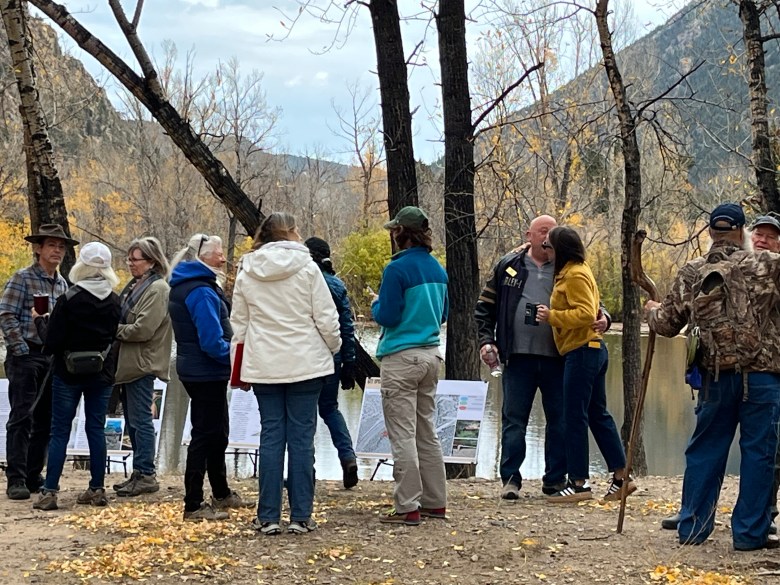 crowd of people trees and pond