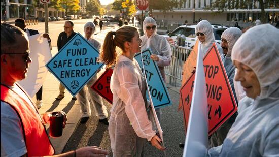 Climate activists protest against in Washington, DC, on October 21. (Bloomberg Photo)