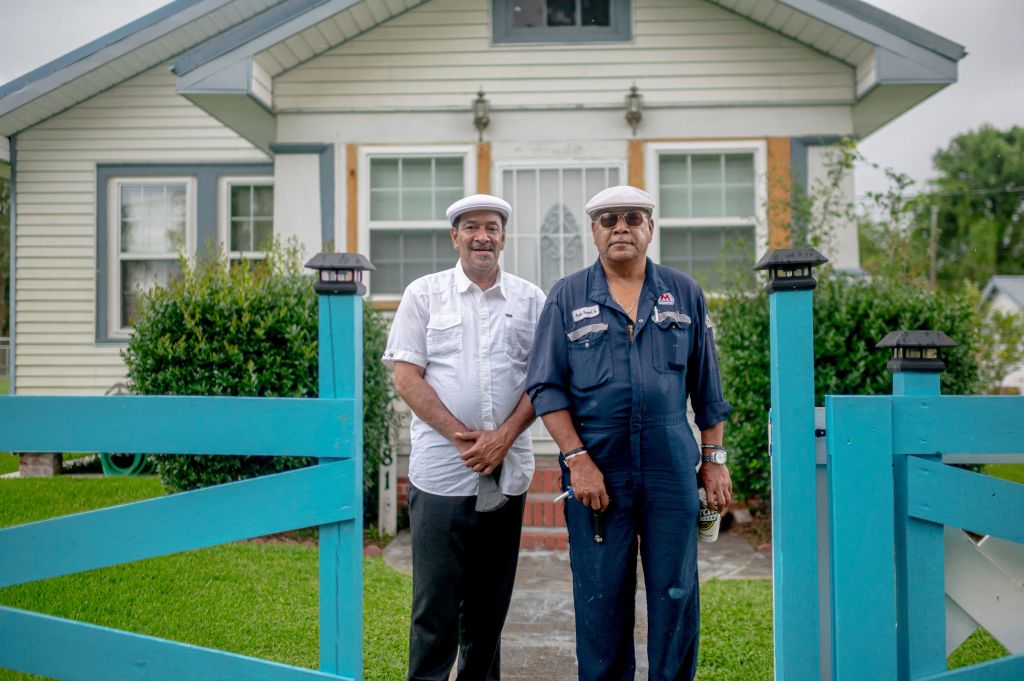 Brothers Byron, left, and Angelo Bernard pose outside a house in Reserve, Louisiana, on August 12, 2021