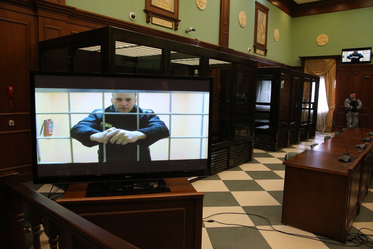 Russian opposition leader Alexey Navalny appears on screen during his appeal against a nine-year sentence at Moscow City Court on May 24, 2022.