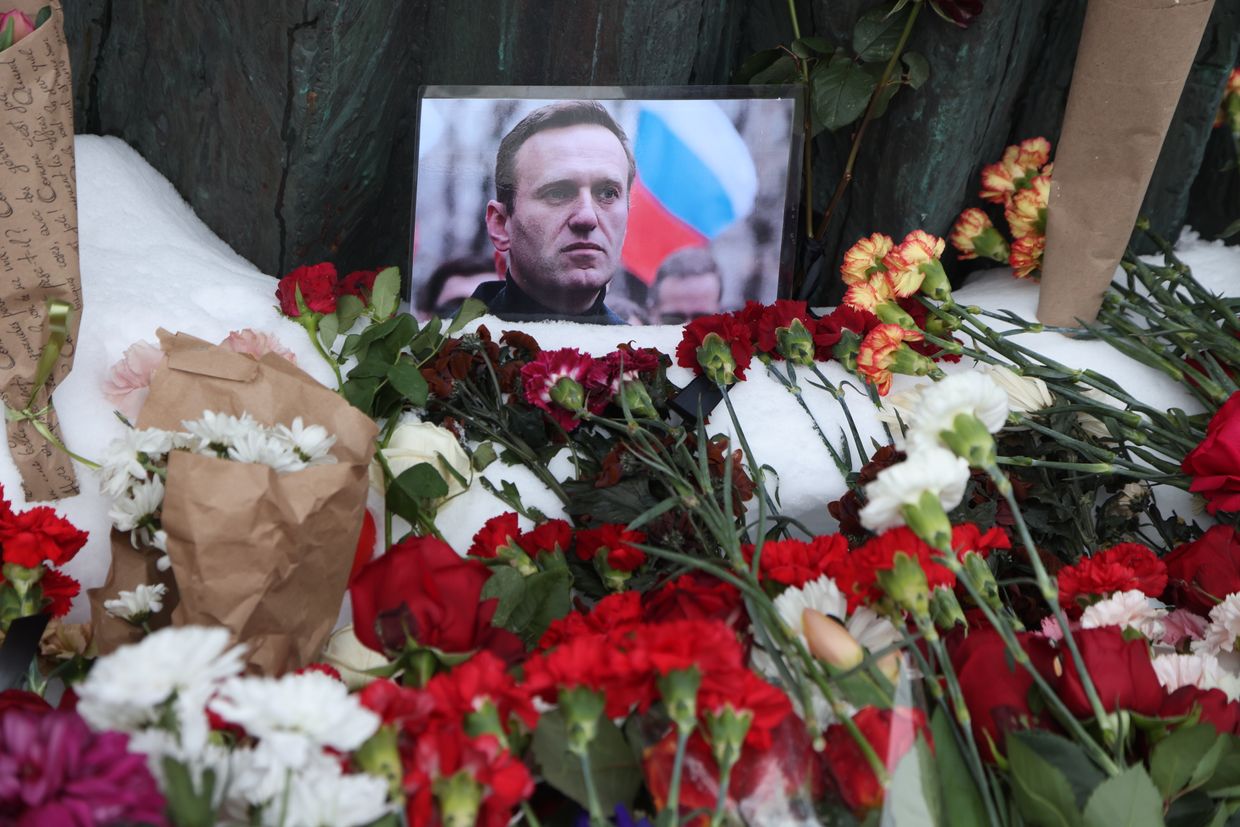 A photo of Alexey Navalny rests among flowers at the Wall of Grief monument in Moscow, Russia, on Feb. 17, 2024.