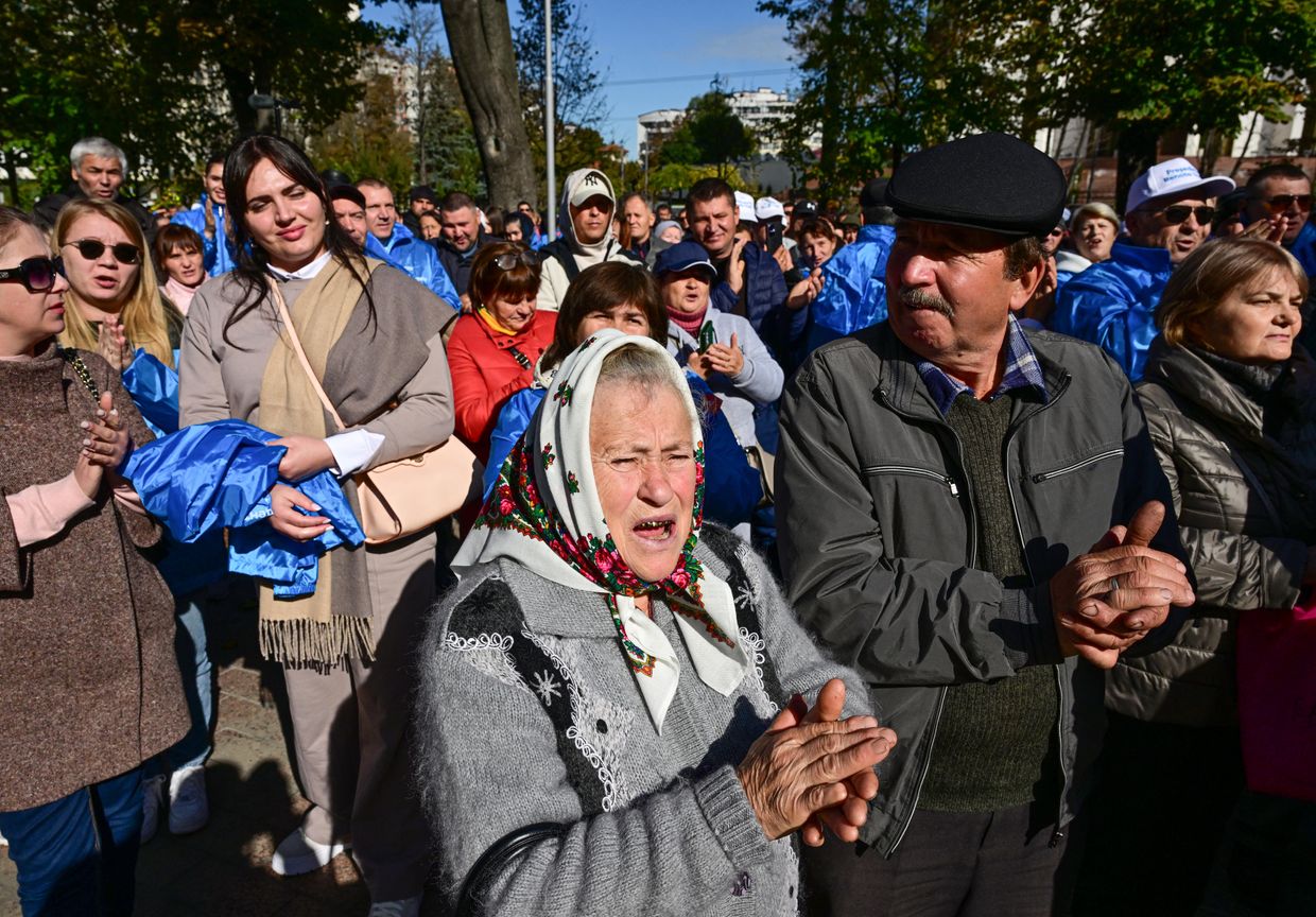  Supporters of "Our Party" candidate Renato Usatii listen to his speech at an electoral meeting outside Parliament in Chisinau on Oct. 18, 2024.