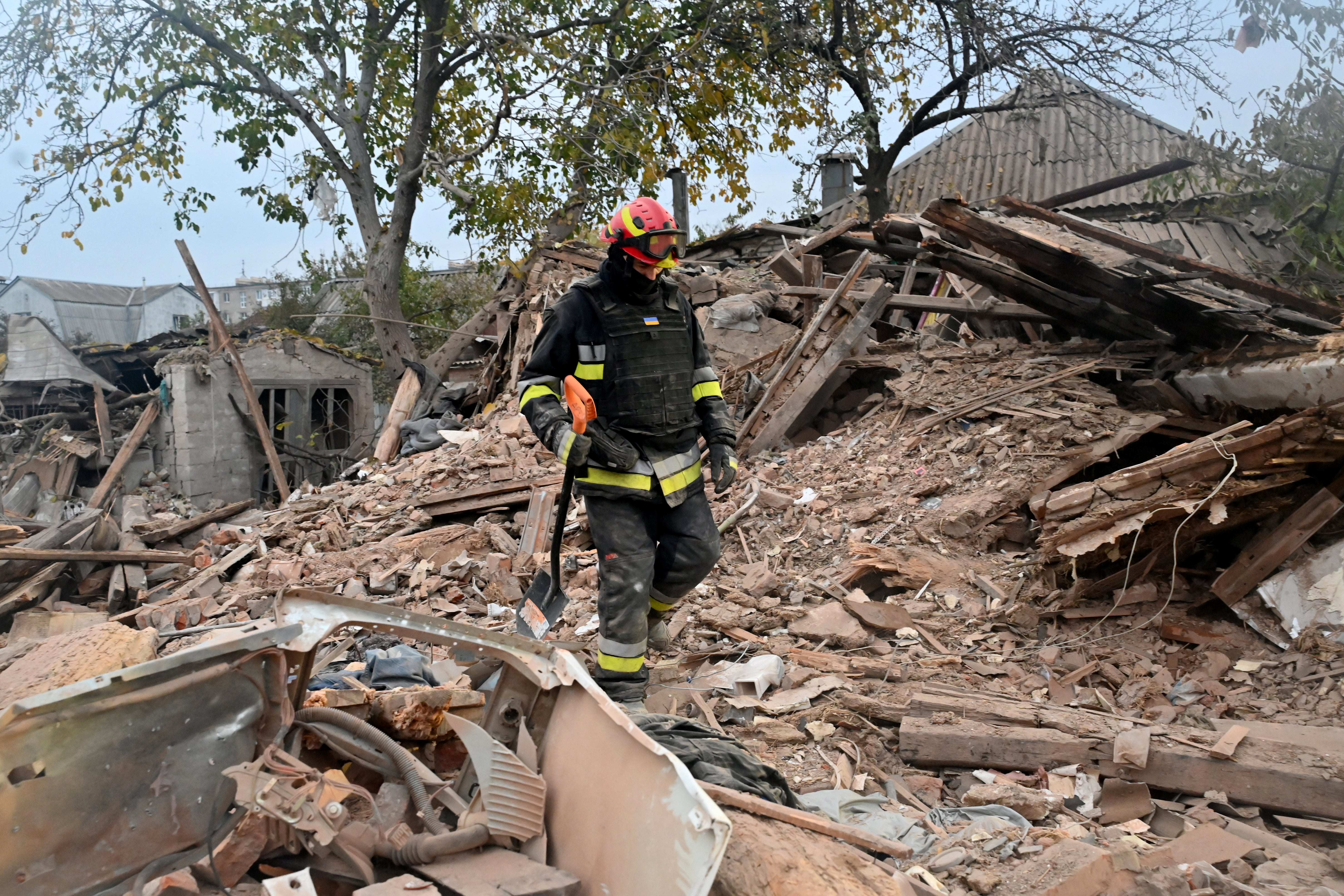 A Ukrainian rescuer works at the site of a missile attack in Kharkiv