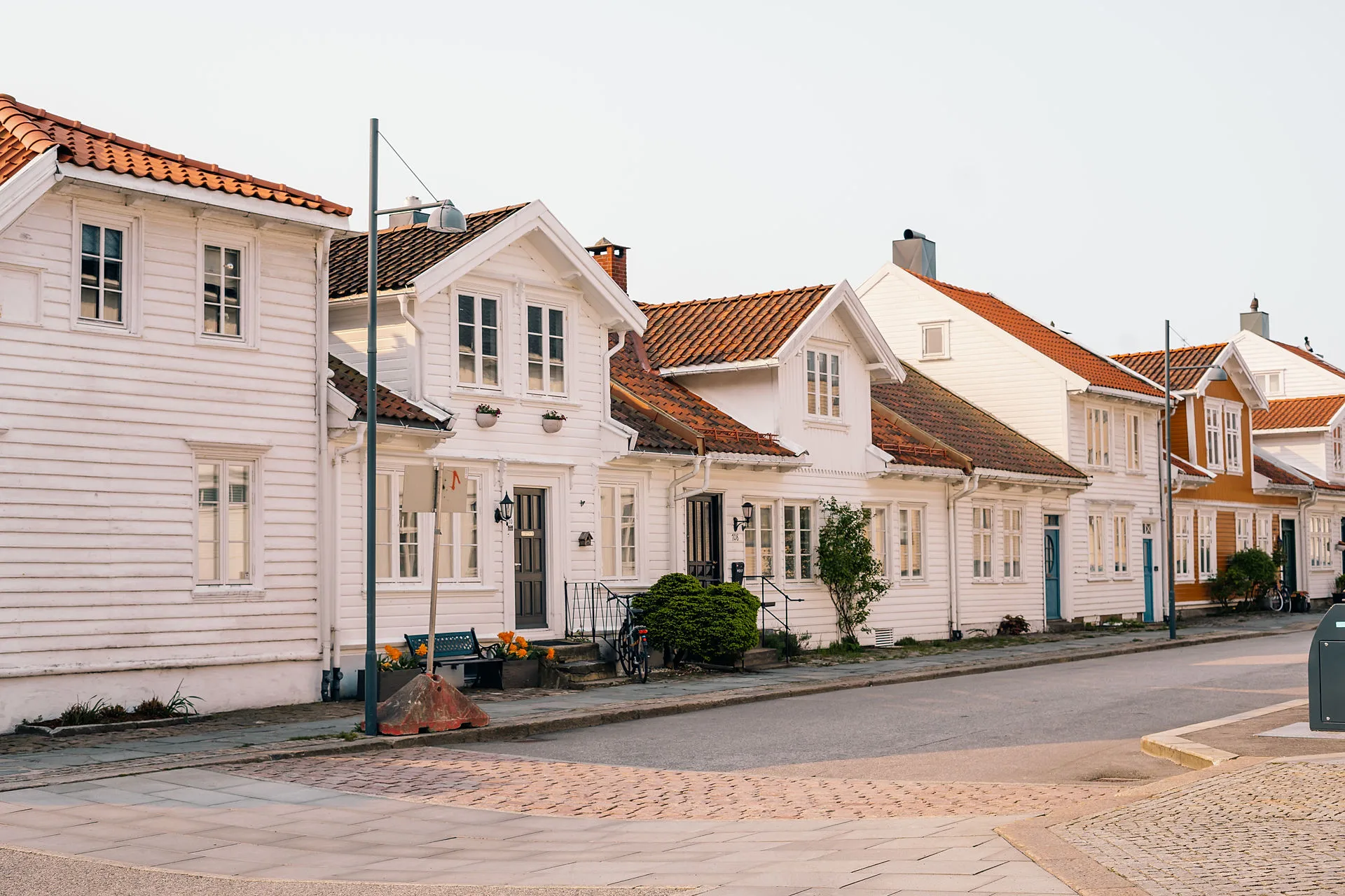 White wooden building on a street in Kristiansand, Norway