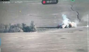 A hit on a Russian armored personnel vehicle sends a crew member into the air