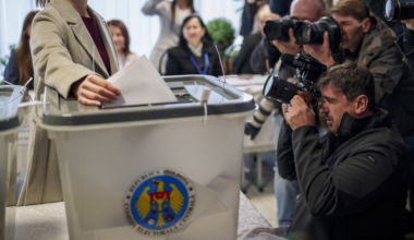 Moldova's President Maia Sandu prepares to cast her vote, in Chisinau, Moldova, Sunday, Oct. 20, 2024, during a presidential election and a referendum on whether to enshrine in the Constitution the country's path to European Union membership. (AP Photo/Vadim Ghirda)