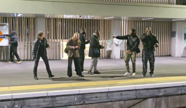 Strangers play a game while waiting for their London Overground train.