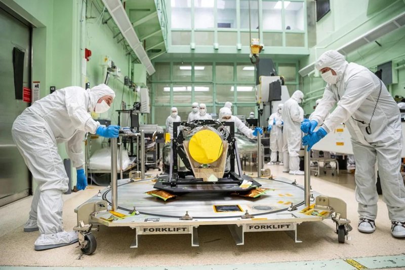 Engineers unpack the full-scale Engineering Development Unit Telescope for the Laser Interferometer Space Antenna mission in a clean room at NASA’s Goddard Space Flight Center in Greenbelt, Md., on May 20. Photo by Dennis Henry/NASA