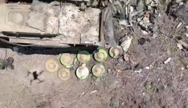 A Ukrainian drone operator drops a grenade on some anti-tank mines close to a disabled Russian tank.