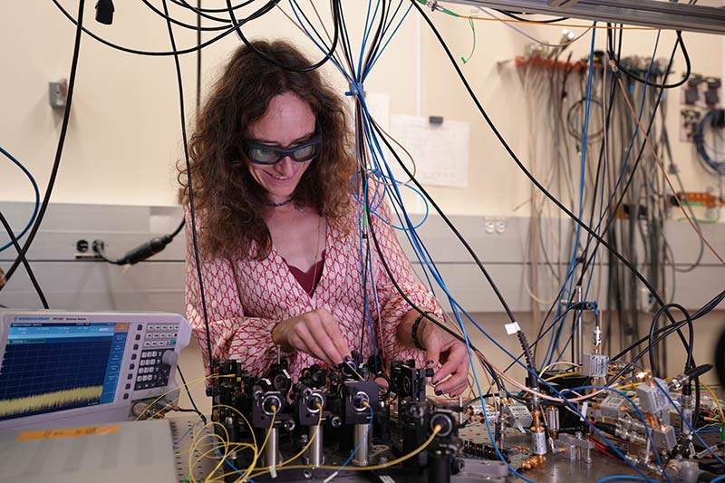 NIST scientist Esther Baumann works in the lab where a team of researchers has developed an improved version of a laser-based measurement technique called dual-comb spectroscopy.  Courtesy of R.Jacobson/NIST.