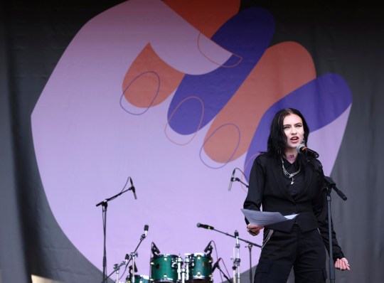 Feminist Urður Bartels gives a speech at the 2023 Women's Day Off - she wears all black and looks powerful