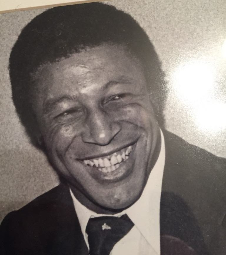 Clive Sullivan smiling at something off camera