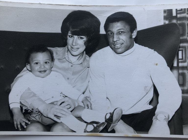 Clive Sullivan (right) with his wife, who is holding one of their children when they were very little