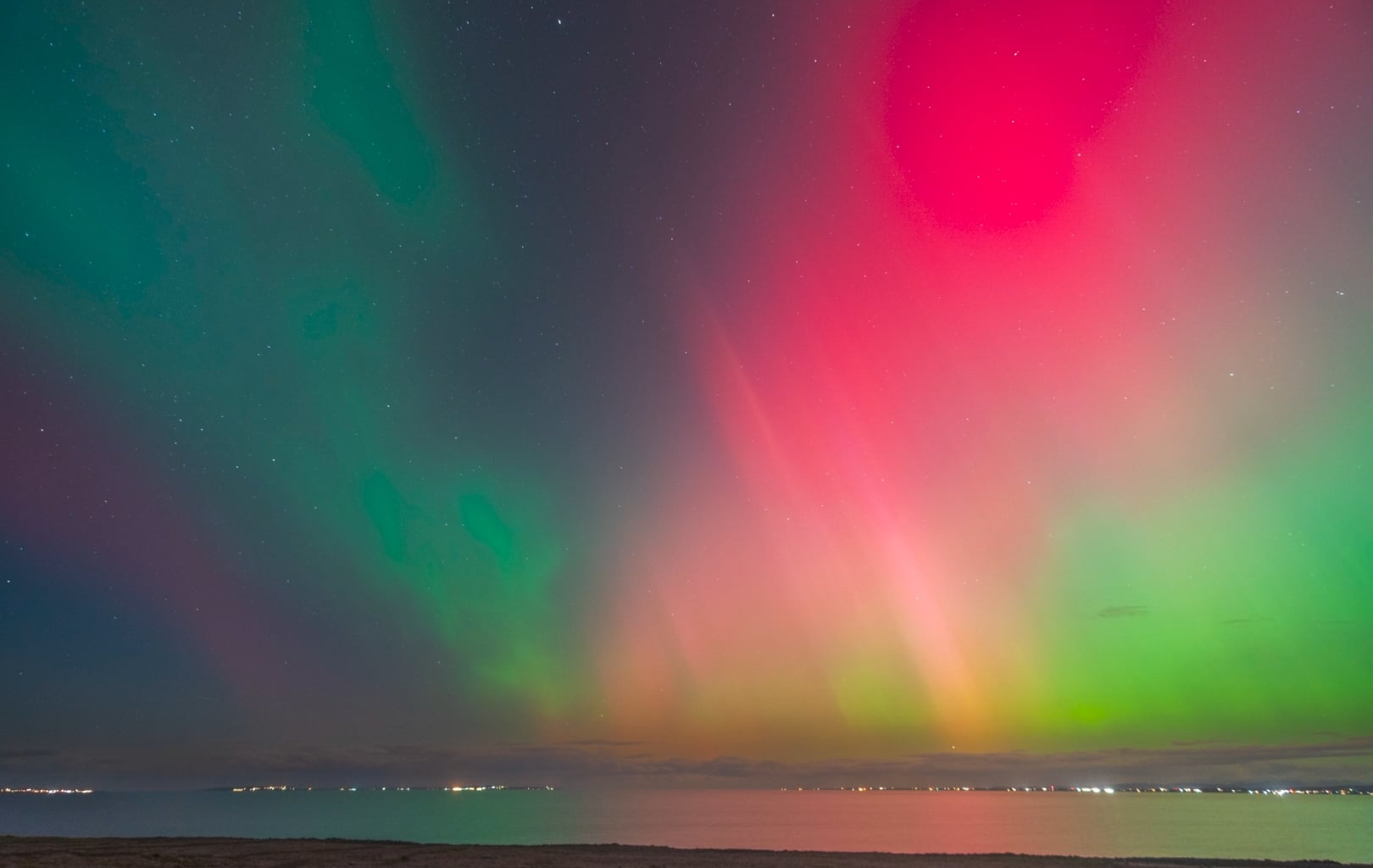 Northern Lights over Aran Islands and Galway coastline