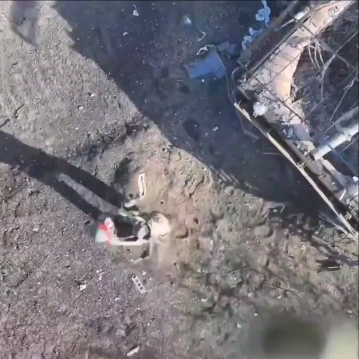 Russian soldier surrendered to a Ukrainian drone after hiding under a destroyed armored vehicle.