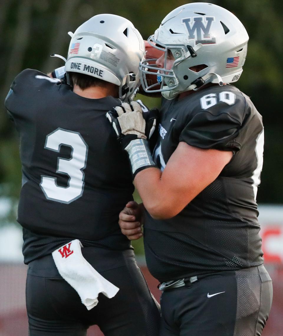 West Lafayette Red Devils quarterback Benny Speaker (3) and West Lafayette Red Devils center Andrew Springer (60) celebrate after a touchdown Friday, Oct. 4, 2024, during the IHSAA football game against the Logansport Berries at Gordon Straley Field in West Lafayette, Ind. Logansport Berries won 28-14.