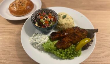 Turkish Adana kebab with coban salatasi, couscous and homemade Turkish mini bread