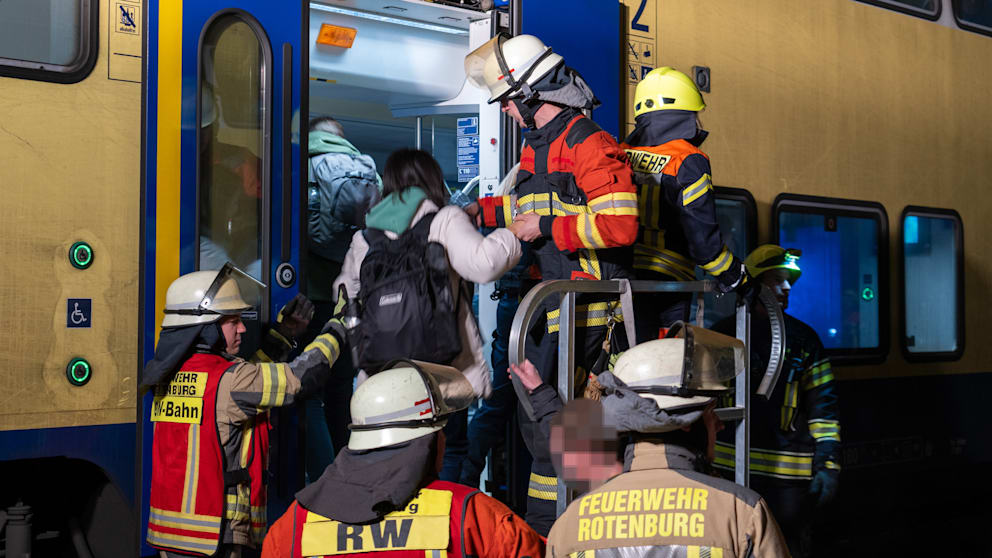 Einsatzkräfte helfen den Reisenden bei Umsteigen in den Ersatzzug