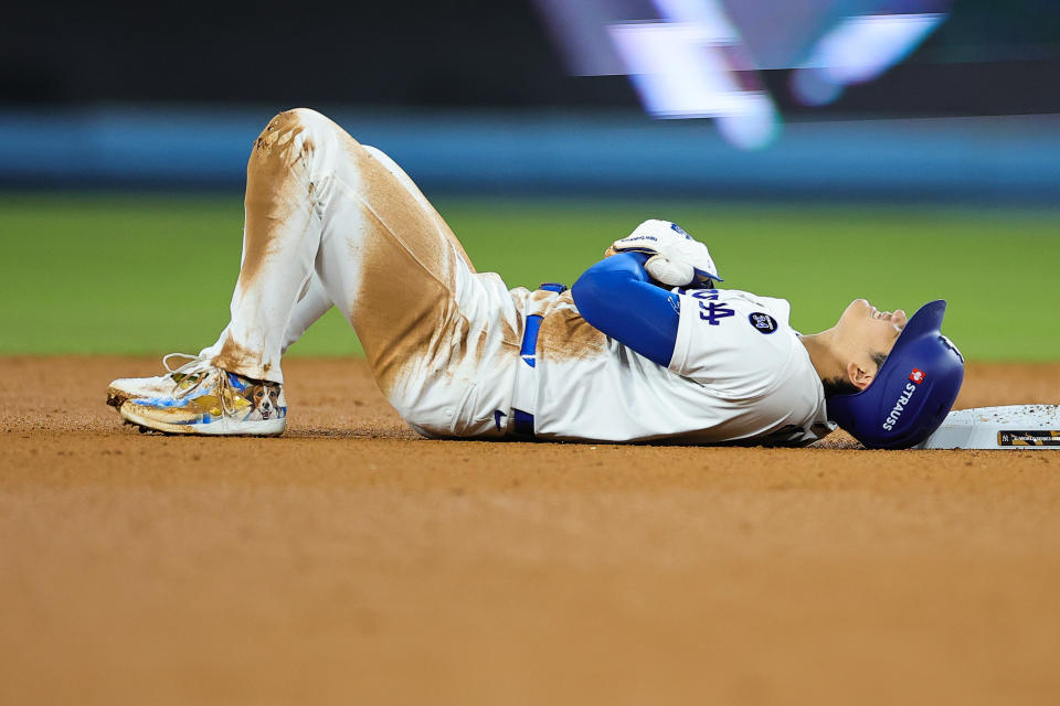 LOS ANGELES, CALIFORNIA - OCTOBER 26: Shohei Ohtani #17 of the Los Angeles Dodgers lies on the ground injured after attempting to steal second base as they play against the New York Yankees in the seventh inning during Game Two of the 2024 World Series at Dodger Stadium on October 26, 2024 in Los Angeles, California. (Photo by Alex Slitz/Getty Images)