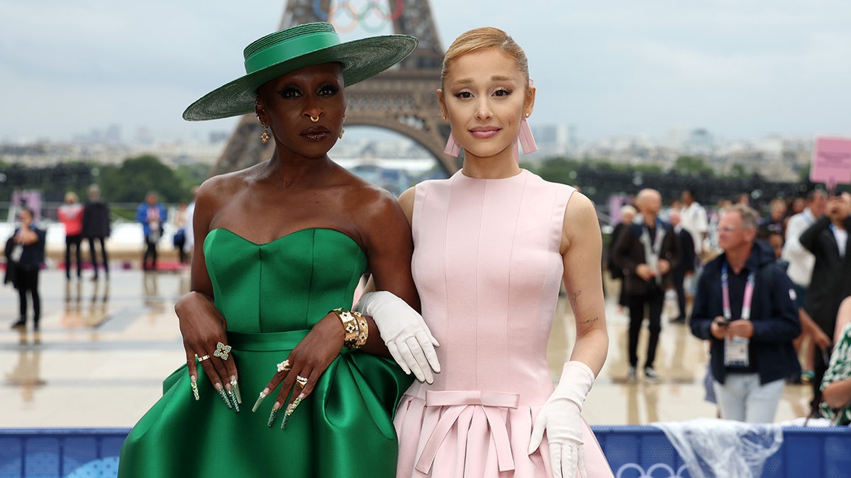 Cynthia Erivo and Ariana Grande posing in front of Eiffel Tower