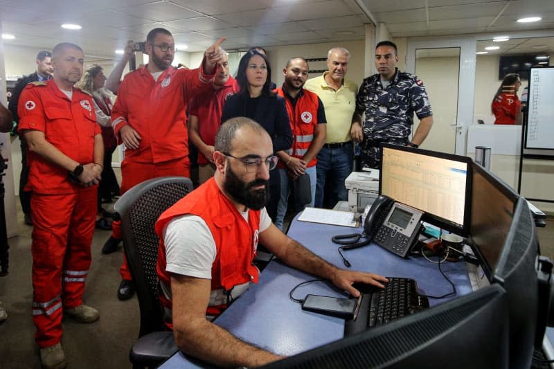 German Foreign Minister Annalena Baerbock is briefed on the safety, security and strategic management during her visit to the Red Cross Crisis Response Center in Hazmieh, southeast of Beirut. Marwan Naamani/dpa