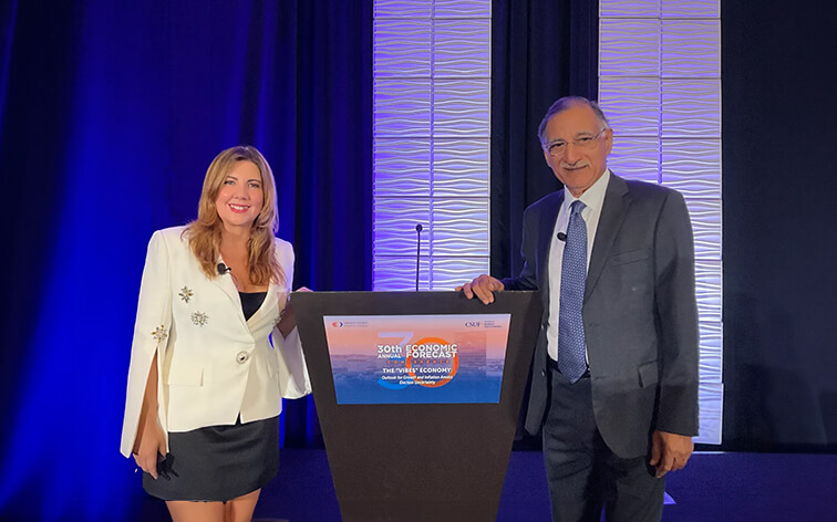 Mira Farka, left, and Anil Puri, pose at a podium at the 30th Annual Economic Forecast Conference on Oct. 24