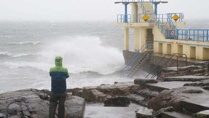 A person watches the waves at the Blackrock diving tower in Salthill, Galway, as a Met Eireann orange alert for Kerry, Leitrim, Sligo, Clare, Donegal, Mayo and Galway came into effect at 10am on Sunday and will be in place to 8pm as Storm Ashley sweeps across the island of Ireland. The forecaster said the first named storm of the season is to bring very strong and gusty south to south-west winds, coupled with high spring tides. The counties covered could see gusts of up to 130kph. Picture date: Sunday October 20, 2024.