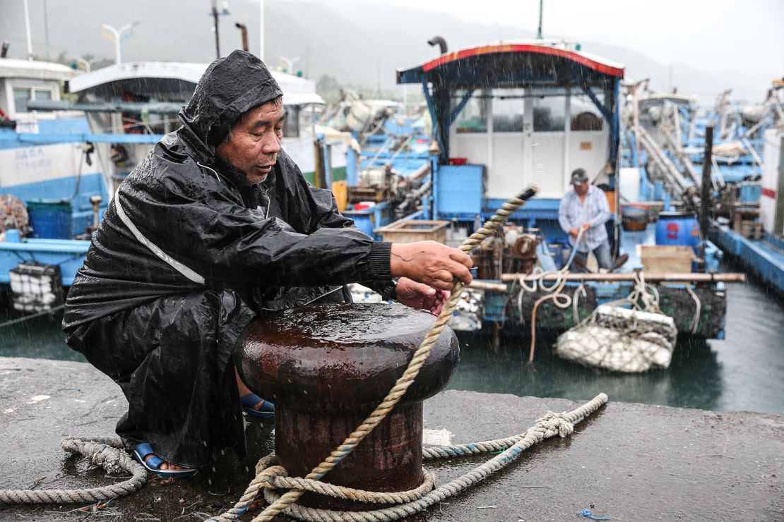 A fisherman secures a boat as Typhoon Kong-rey approaches Taiwan, in Yilan County on October 30, 2024.