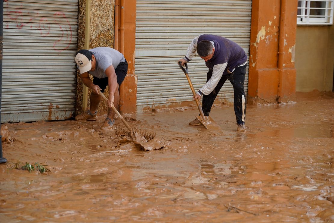 VALENCIA, SPAIN - OCTOBER 30: Residents clean the roads after a deluge brought up to 200 liters of rain per square meter (50 gallons per square yard) in hours in towns across the region of Valencia, Spain on October 30, 2024. Catastrophic flooding in Spain's Valencia region has left 51 people dead, according to provisional data reported by the Interior Ministry's Center for Integrated Operational Coordination.The storm, dropping a year's worth of rain in hours, causing rivers to quickly burst their banks and even spawning tornadoes. (Photo by Alex Juarez/Anadolu via Getty Images)