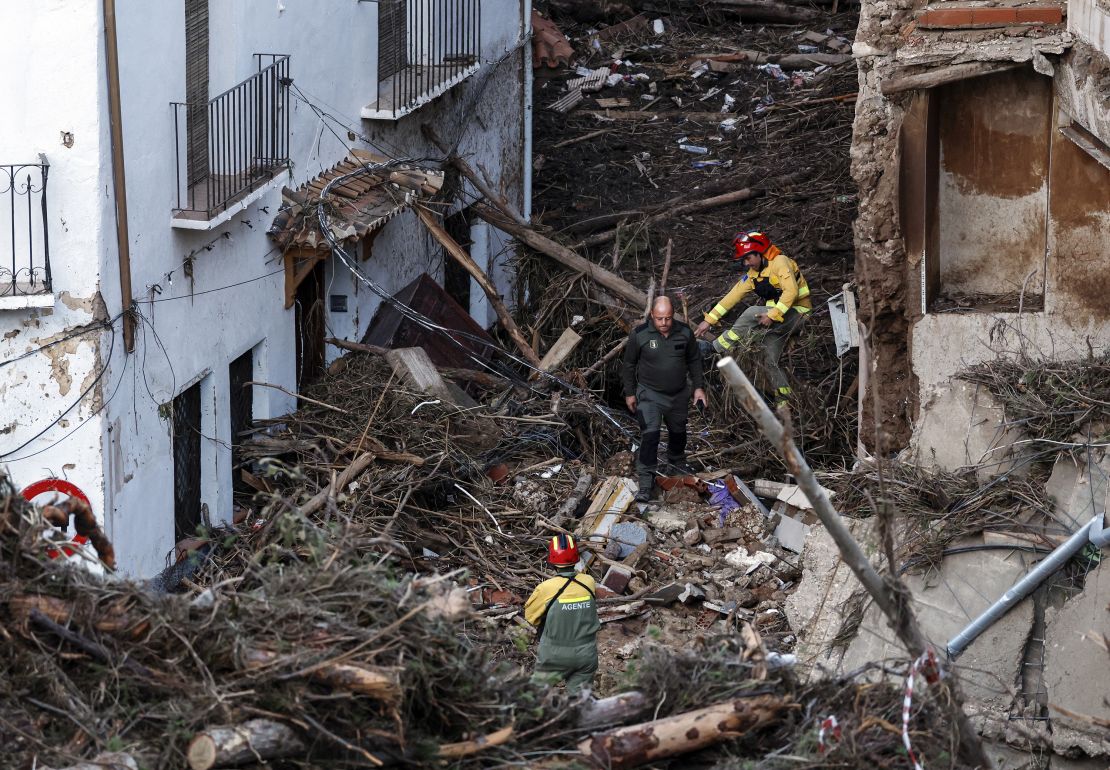 Members of the emergency services work in a devastated street in the Spanish town of Letur, southwest of Valencia, on Wednesday.