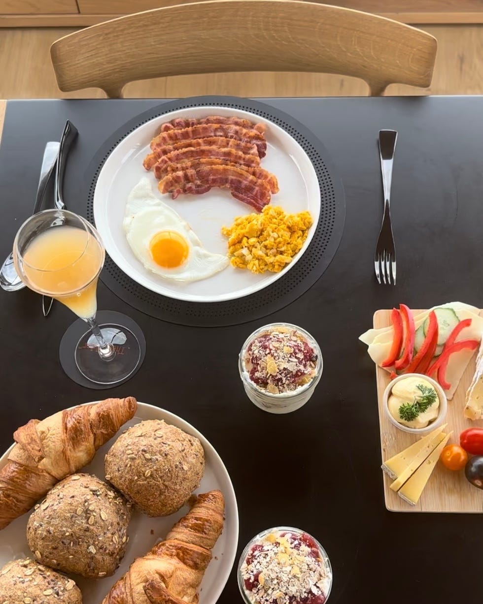 the scene features a variety of breakfast items arranged on a table