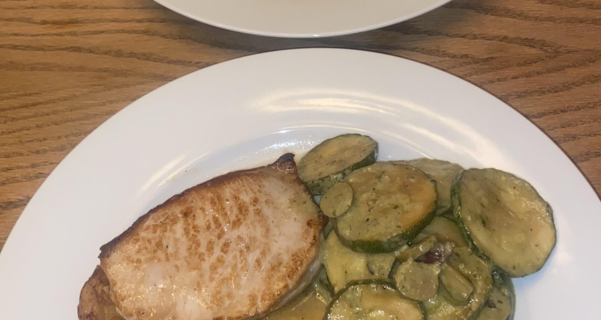 pork chops, pesto braised courgette, roast potatoes, pork jus