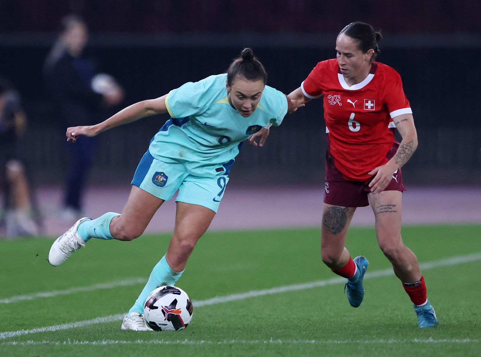 Caitlin Foord of Australia controls the ball under pressure from Geraldine Reuteler of Switzerland