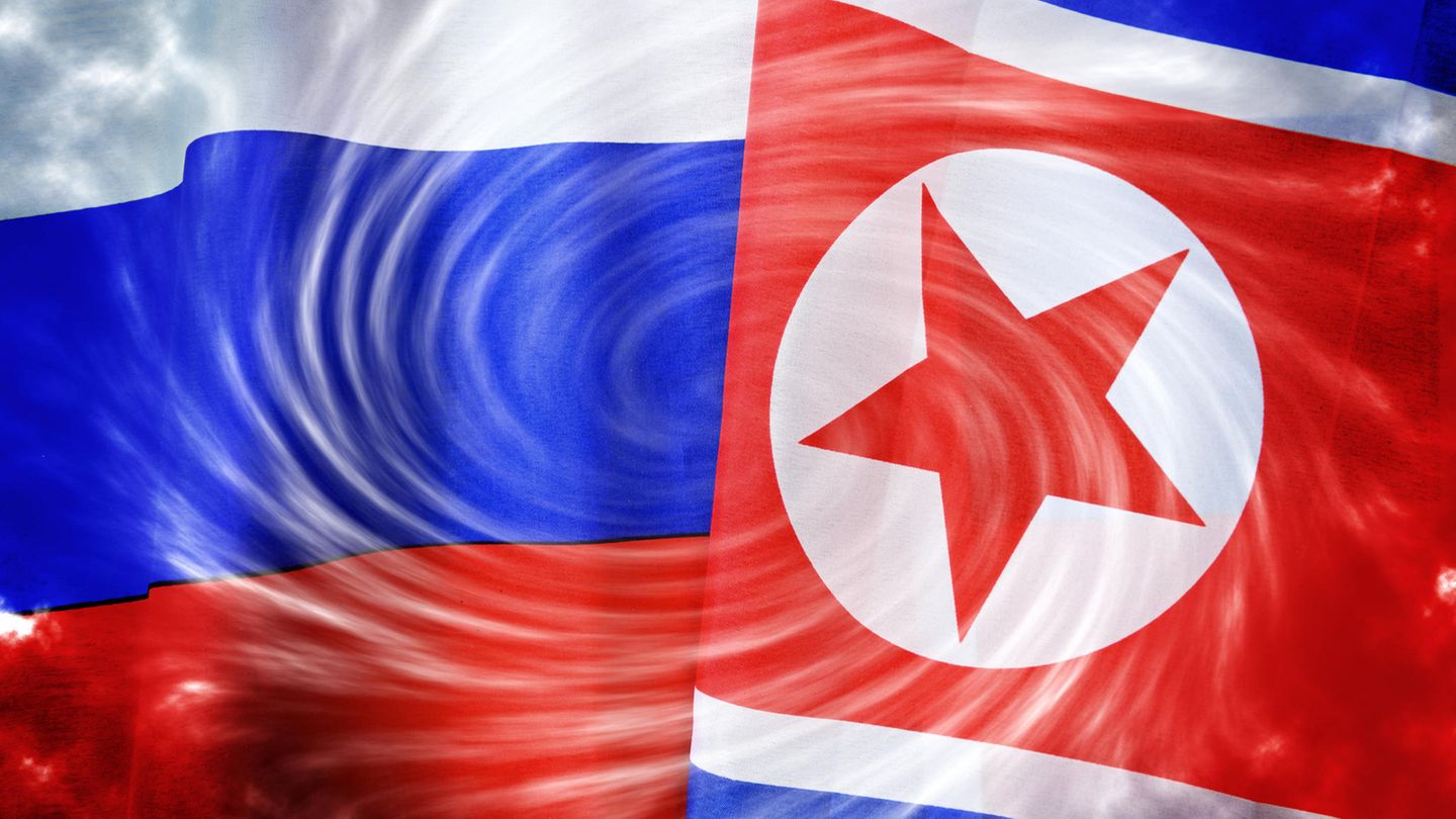 Die Flaggen von Russland und Nordkorea liegen übereinander, in der Mitte sieht man einen Wirbelsturm