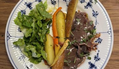 Venison in a red wine sauce with root vegetables and a basic salad