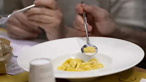 Getty Images In Emilia-Romagna, tortellini are almost always eaten in broth, but modern chefs like Massimo Bottura experiment with a dressing of Parmigiano cream (Credit: Getty Images)