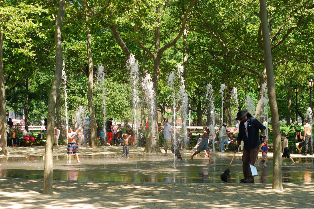 Individual jets of water provide a tree-shaded splash pad for kids to play in