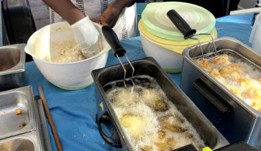 A Senegalese farmers’ market purveyor molds balls of batter and dips them into a bubbling tub of oil to form delicious pumpkin caribbean fritters. These accras reflect the high quality of food found throughout the local French market.